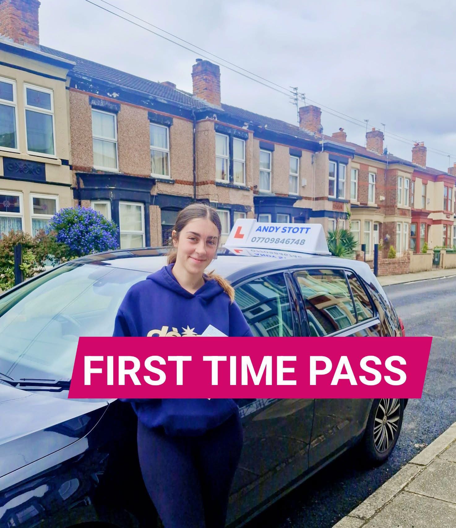 Meg celebrating her first-time driving test pass in Wallasey next to Andy Stott's car